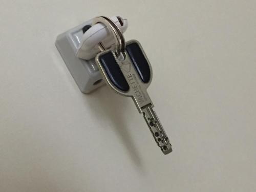 a pair of keys sitting on top of a table at Hôtel Le Boulevardier in Lyon