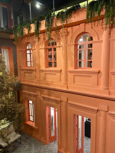 a building with windows and plants on the side of it at CASA ANABELA HOTEL BOUTIQUE in Quito