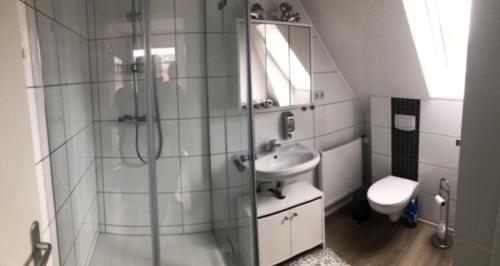 a bathroom with a shower and a sink and a toilet at Am alten Marktplatz in Norden