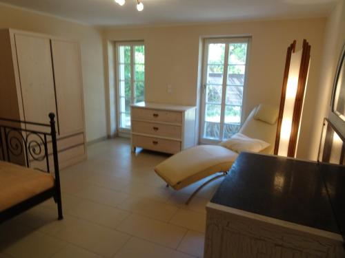 a living room with a bed and a dresser at Das Gäste Haus in Dresden