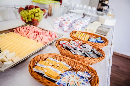 a buffet with baskets of meats and cheese at Hotel Gong in Štramberk