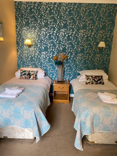 A bed or beds in a room at The Ardingly Inn 