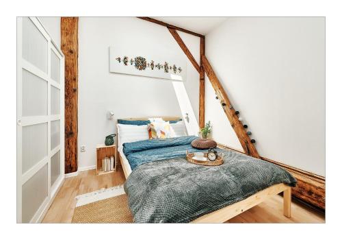 a bedroom with a bed with a blue blanket at Sunny Apartment at the Heart of Old Town in Krakow