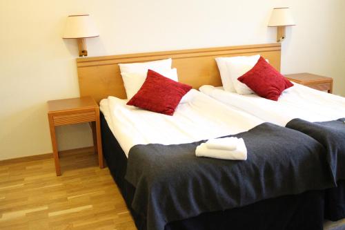 Säng eller sängar i ett rum på Arena Hotell