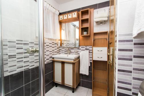 a bathroom with a sink and a mirror at Beach House Jadrija in Šibenik