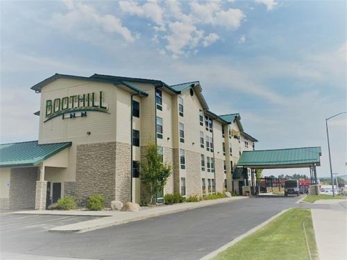 a large building with a sign on the side of it at Boothill Inn and Suites in Billings