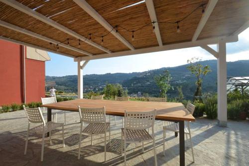 a wooden table and chairs on a patio at Laserrafelice in Imperia