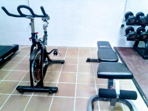 a bike parked in a gym with weights at Al-Andalus Thalassa Home Star in Vera