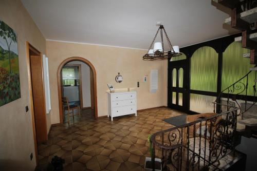 a living room with a white dresser and a hallway at Wiegmann´s Ferienhaus in Mechernich