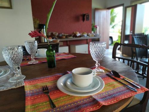 a wooden table with a cup and a plate on it at Terrazzo Suites in Capitólio