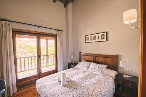 a bedroom with a bed and a large window at Desconnectar Pi De Cerdanya in Bellver de Cerdanya