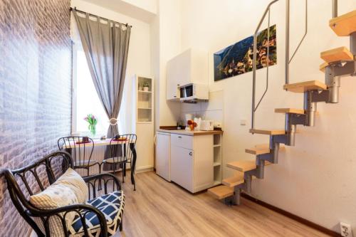 a living room with a staircase and a kitchen at K&S Apartments in Berlin