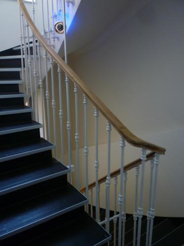a staircase with black treads and white railings at Hôtel de France in Monte Carlo