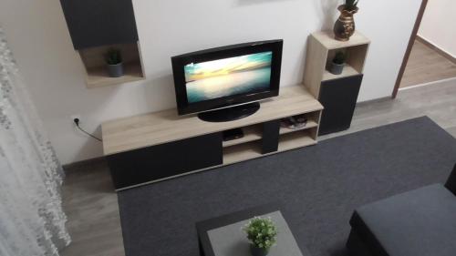 a living room with a flat screen tv on a stand at Ellada Apartment in Athens