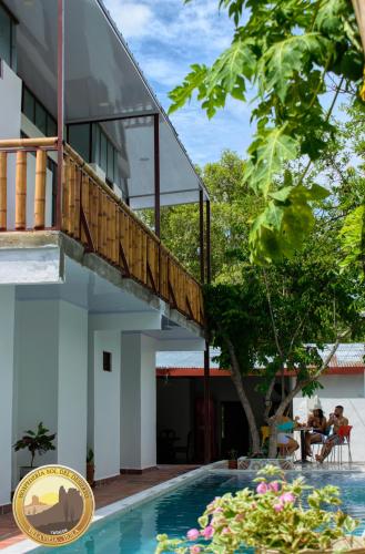 a house with a swimming pool with a balcony at Hotel Sol del Desierto in Villavieja