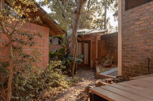 a brick house with a porch and a tree at Descanso Verde in Oberá