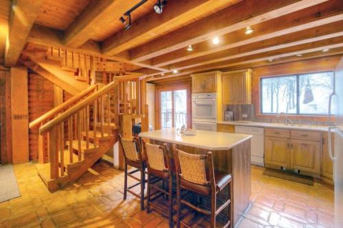 a kitchen with a table and chairs and a staircase at Log Cabin On The Stream Sundance, Utah in Sundance