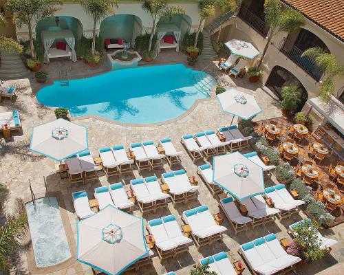 an overhead view of a pool with chairs and umbrellas at Beverly Wilshire, A Four Seasons Hotel in Los Angeles