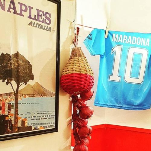a wall with a shirt and a basket hanging on a wall at Appartamenti Mergellina in Naples