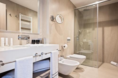 a bathroom with a sink and a toilet and a shower at Hotel AMI Budva Petrovac in Petrovac na Moru