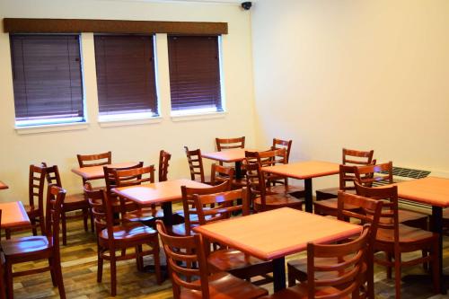 a room filled with wooden tables and chairs at SureStay Hotel by Best Western Wenatchee in Wenatchee