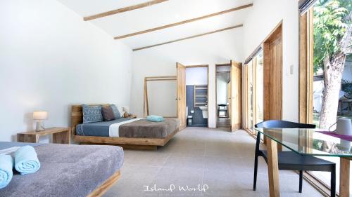 a bedroom with a bed and a glass table at Island World Panglao in Panglao