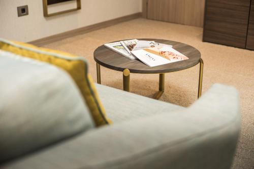 a coffee table with a book on it next to a couch at Hotel AMI Budva Petrovac in Petrovac na Moru