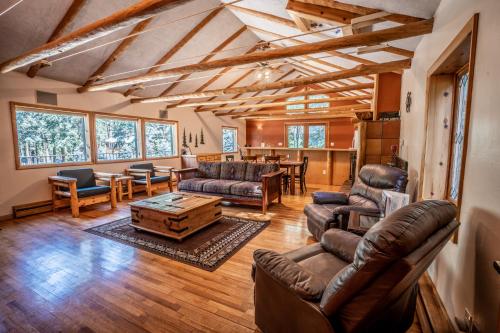 a living room filled with furniture and a large window at Colorado Bear Creek Cabins in Evergreen