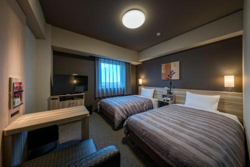 Hotel Route-Inn Kamisu 객실 침대