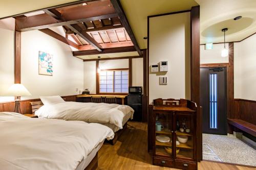 Ένα ή περισσότερα κρεβάτια σε δωμάτιο στο Wow! KANAZAWA STAY