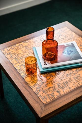 a table with a bottle and two glasses on it at The Old Clare by Ode Hotels in Sydney