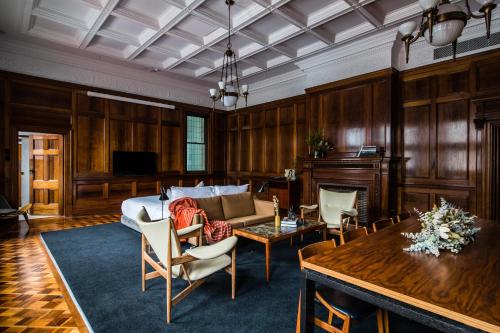 a living room with a bed and a table at The Old Clare by Ode Hotels in Sydney