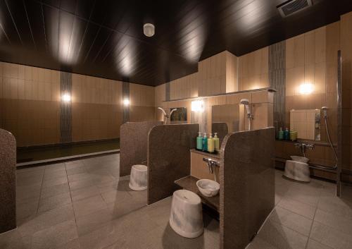 a bathroom with three toilets in a public restroom at Hotel Route-Inn Ichihara in Ichihara