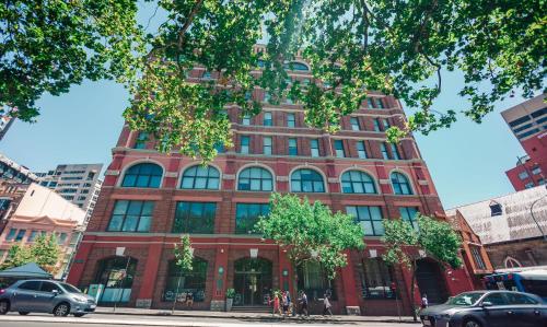 a red brick building on a city street at Wake Up! Sydney Central in Sydney