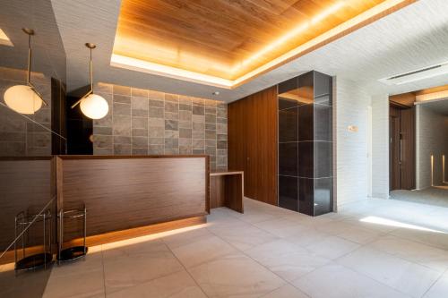 a lobby with a reception desk in a building at HOTEL All Stay Hakata Kukodori in Fukuoka