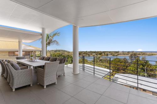 an outdoor patio with a table and chairs and a view of the water at Shawhaven in East Ballina