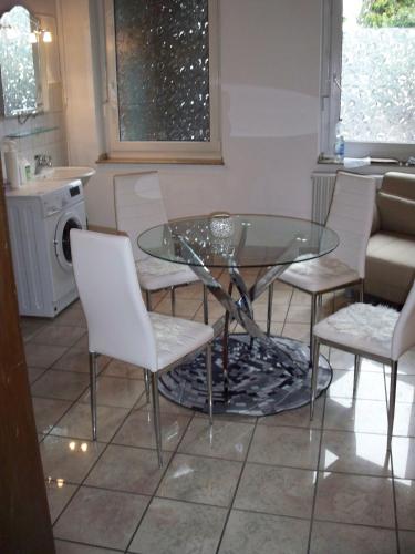 a glass table and chairs in a kitchen at 2 Raum Wohnung in Krefeld