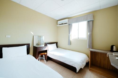 מיטה או מיטות בחדר ב-Jin Lu Homestay