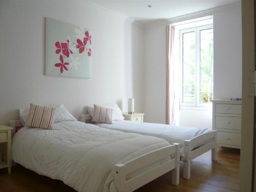 a white bedroom with a bed and a window at Nice - Paillon apartment by Stay in the heart of ... in Nice