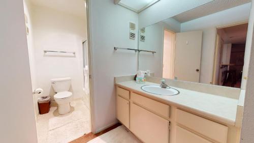 La salle de bains est pourvue d'un lavabo, de toilettes et d'un miroir. dans l'établissement Mammoth Reservations, à Mammoth Lakes