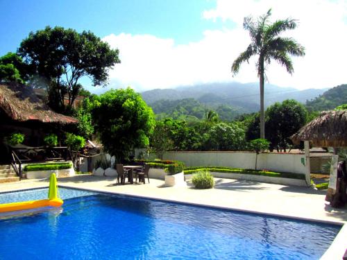 a swimming pool with a view of a mountain at Hostal Villa Cata in El Zaino