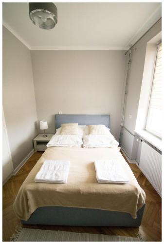 a bedroom with a bed with two towels on it at Color 24 Apartament III in Stalowa Wola