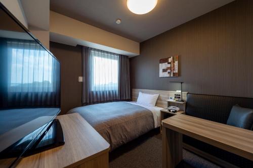 Кровать или кровати в номере Hotel Route-Inn Kanuma Inter