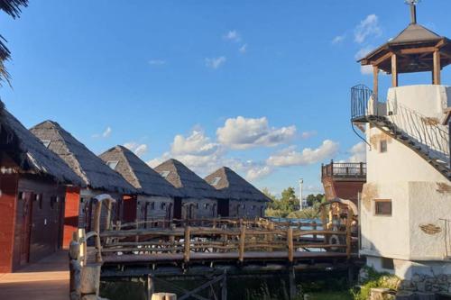 a group of buildings with a wooden bridge at Houseboat Slnečné jazerá, apartmán 1 in Senec