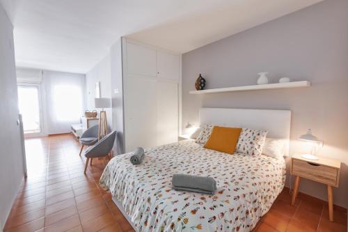 a bedroom with a bed with a suitcase on it at Desconnectar Tossa de Mar in Tossa de Mar