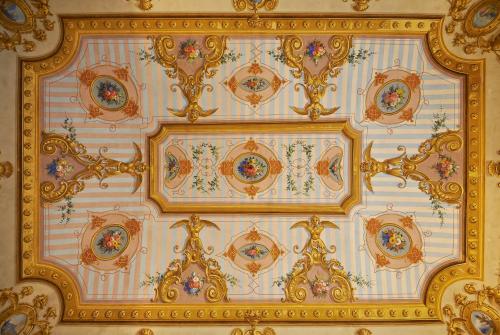 a ceiling of a building with gold and white at Hotel Firenze Capitale in Florence