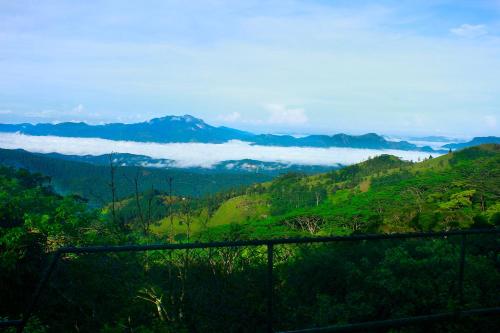 a view of a valley with clouds in the mountains at The Riverston Grand in Matale
