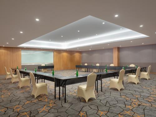 a large conference room with a long table and chairs at AIHO Hotel Medan in Medan