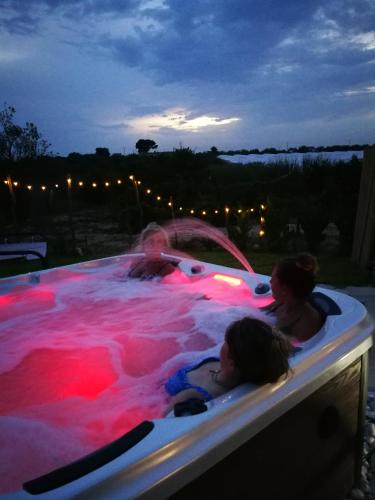 a group of people swimming in a jacuzzi at Ciriga Sicily Glamping in Santa Maria Del Focallo