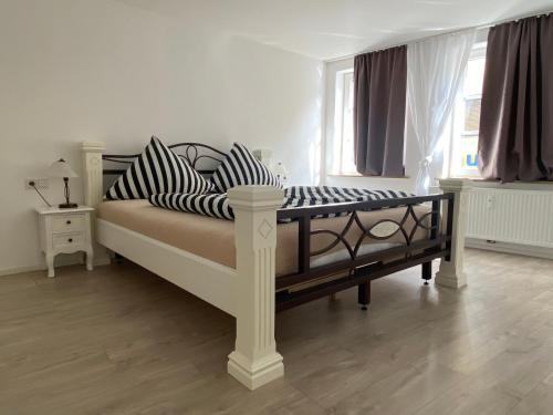 a white bed with striped pillows in a bedroom at Sky in Überlingen